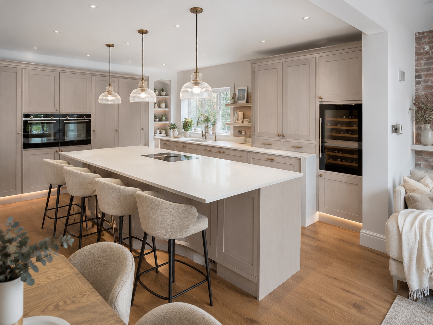 Nobilia Frame Macchiato kitchen-diner with island seating, pale grey marble-effect quartz surface, warm wood flooring, neutral furniture and garden-facing glazing in a UK home.
