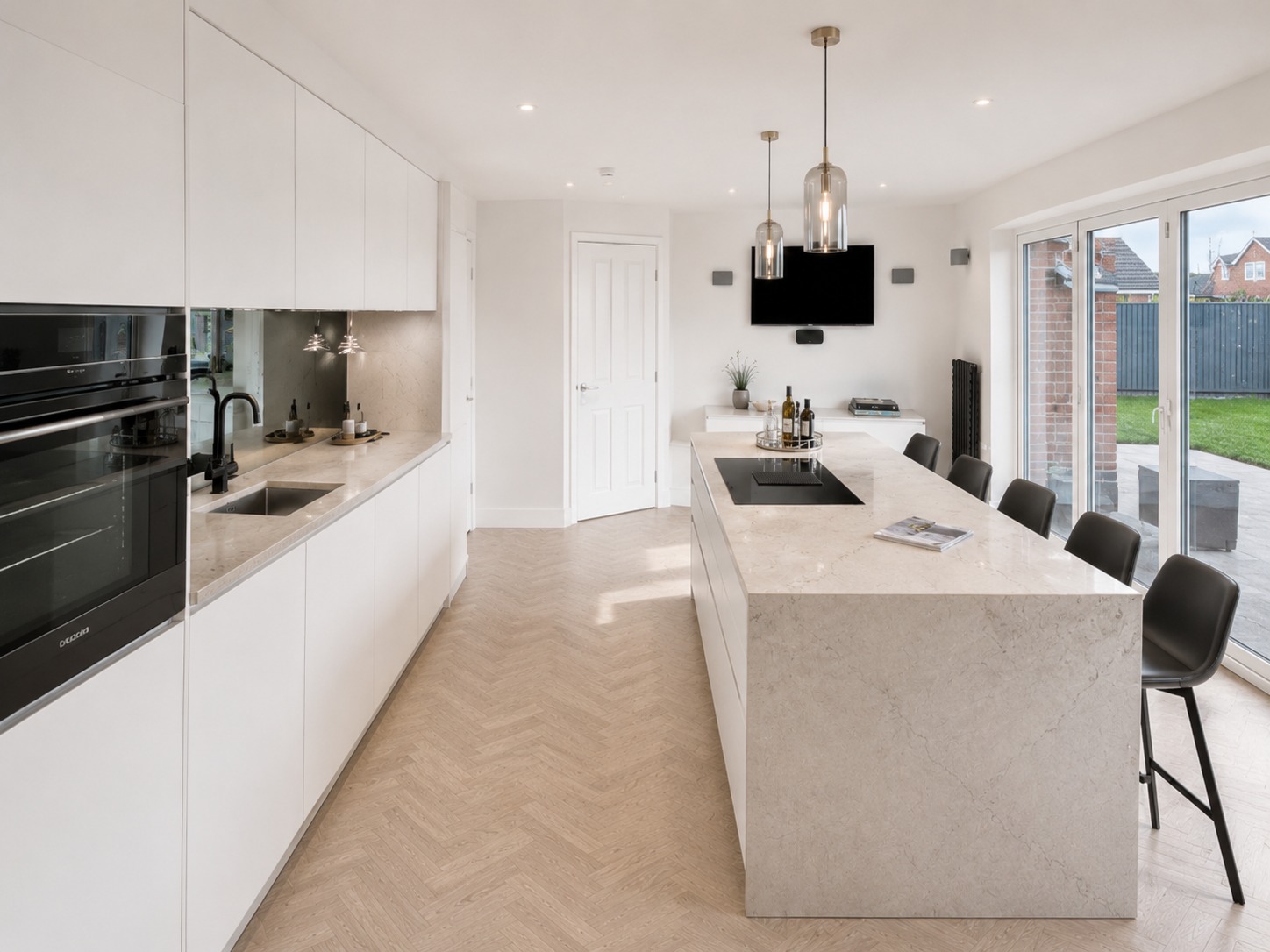 Nobilia Touch Slate Grey kitchen with dark Slate Grey supermatt cabinetry, light quartz worktops, coordinated flooring, island seating and a balanced side-angle layout.